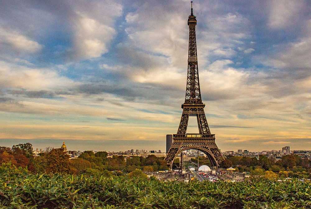 Claire, guide virtuelle IA, expliquant l'histoire de la Tour Eiffel aux visiteurs.